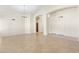 Neutral living room with tiled floors, high ceilings and access to other rooms at 7910 W Adobe Dr, Glendale, AZ 85308