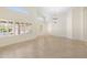 Bright and airy living room with tiled floors, plantation shutters, high ceilings, and large windows at 7910 W Adobe Dr, Glendale, AZ 85308