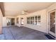 Covered patio area ideal for outdoor lounging and entertaining with multiple windows and doors at 7910 W Adobe Dr, Glendale, AZ 85308