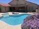 Inviting backyard pool with attached spa, desert landscaping, and a covered patio at 7910 W Adobe Dr, Glendale, AZ 85308