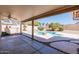 Beautiful pool view from covered patio, showcasing spa, landscaping and outdoor living at 7910 W Adobe Dr, Glendale, AZ 85308