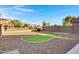 Large backyard with gravel landscaping, an artificial putting green, and block wall fencing at 8005 S 69Th Ln, Laveen, AZ 85339