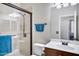 Well-lit bathroom with a glass-enclosed shower, a sink with vanity, and a toilet at 8005 S 69Th Ln, Laveen, AZ 85339