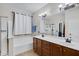 Bright bathroom with double vanity, tub, shower, and modern fixtures at 8005 S 69Th Ln, Laveen, AZ 85339