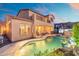 Twilight view of the backyard pool with covered patio and desert mountain views at 8432 S 21St Pl, Phoenix, AZ 85042