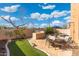 Backyard featuring a built-in barbecue, dining area, and a landscaped pool area at 8432 S 21St Pl, Phoenix, AZ 85042