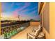 Evening balcony view with wrought iron railing, comfortable seating, and beautiful sunset at 8432 S 21St Pl, Phoenix, AZ 85042