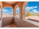 Outdoor balcony featuring arched detailing, tile floors, and scenic exterior views of surrounding properties at 8432 S 21St Pl, Phoenix, AZ 85042