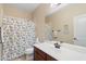 Bright bathroom with a single sink vanity and a playful patterned shower curtain at 8432 S 21St Pl, Phoenix, AZ 85042