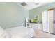 Light green bedroom featuring a dresser with a TV, and soft carpet flooring at 8432 S 21St Pl, Phoenix, AZ 85042