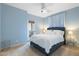 Calming blue bedroom featuring a queen bed and a balcony door for natural light at 8432 S 21St Pl, Phoenix, AZ 85042