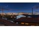 Night view shows lit city skyline with a mountain view from the home's rooftop at 8432 S 21St Pl, Phoenix, AZ 85042