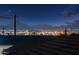 City skyline view with mountain backdrop showcases lights against a dark sky from rooftop at 8432 S 21St Pl, Phoenix, AZ 85042