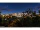 Nighttime view of the city skyline from this property with distant lights and crescent moon at 8432 S 21St Pl, Phoenix, AZ 85042