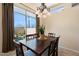 Dining room features chandelier, tiled floors, and an open view into the outdoor area at 8432 S 21St Pl, Phoenix, AZ 85042