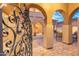 Inviting courtyard entrance, framed by elegant archways and a decorative wrought iron gate at 8432 S 21St Pl, Phoenix, AZ 85042