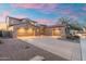 Stunning home with a tile roof, large driveway, and a three-car garage, illuminated by a gorgeous sunset at 8432 S 21St Pl, Phoenix, AZ 85042