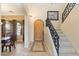 Elegant foyer featuring a wooden door, decorative tile, staircase with iron railing, and bright natural light at 8432 S 21St Pl, Phoenix, AZ 85042