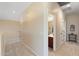 Neutral hallway with carpet flooring leading to a bathroom with a dark wood vanity at 8432 S 21St Pl, Phoenix, AZ 85042