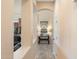 Inviting hallway with tiled floor, archways and neutral paint, leading to living spaces at 8432 S 21St Pl, Phoenix, AZ 85042