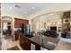 Kitchen island with granite countertops, a double sink, seating, and an open view into the living room at 8432 S 21St Pl, Phoenix, AZ 85042