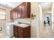 Laundry room with built-in cabinets and an adjacent utility sink at 8432 S 21St Pl, Phoenix, AZ 85042