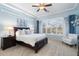 Bright main bedroom featuring a ceiling fan, large windows, and a cozy seating area at 8432 S 21St Pl, Phoenix, AZ 85042