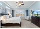 Spacious main bedroom features a ceiling fan, a tv, and natural light through the windows at 8432 S 21St Pl, Phoenix, AZ 85042