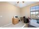 Cozy home office with neutral walls, a printer, and a view from a large window at 8432 S 21St Pl, Phoenix, AZ 85042