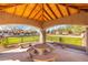 Covered seating area includes benches and stone table for relaxing and enjoying the community at 8432 S 21St Pl, Phoenix, AZ 85042