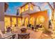 Inviting outdoor patio with comfortable seating around a fire pit, illuminated by warm sunset lighting at 8432 S 21St Pl, Phoenix, AZ 85042