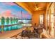 Outdoor seating area overlooking a custom swimming pool with rock water feature and mature trees at 8432 S 21St Pl, Phoenix, AZ 85042