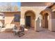 Serene outdoor patio area with comfortable seating, featuring an arched entryway at 8432 S 21St Pl, Phoenix, AZ 85042