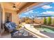 Relaxing covered patio with a ceiling fan, outdoor seating, and a view of the backyard pool at 8432 S 21St Pl, Phoenix, AZ 85042