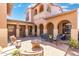 Inviting outdoor patio with comfortable seating around a fire pit, bathed in sunlight at 8432 S 21St Pl, Phoenix, AZ 85042