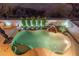 Aerial view of a backyard pool with rock waterfall feature and landscaping, creating a serene oasis at 8432 S 21St Pl, Phoenix, AZ 85042