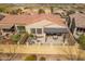 Aerial view of home with patio, built-in barbecue, and fire pit at 9041 E Ivyglen Cir, Mesa, AZ 85207