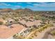 Beautiful aerial view of the neighborhood's tile roofs, desert landscaping, and mountain backdrop at 9041 E Ivyglen Cir, Mesa, AZ 85207