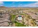 Gorgeous aerial view of the community pool and surrounding desert landscape at 9041 E Ivyglen Cir, Mesa, AZ 85207