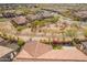 Stunning aerial view showcases the tile roof and well-kept landscaping of this desert home at 9041 E Ivyglen Cir, Mesa, AZ 85207