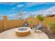 Backyard features a fire pit and chairs at 9041 E Ivyglen Cir, Mesa, AZ 85207