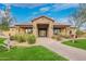 Elegant stone and brick entrance to the community pool with well-manicured landscaping at 9041 E Ivyglen Cir, Mesa, AZ 85207