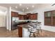 This kitchen has dark wood cabinets, stainless steel appliances, and bar stool seating at 9041 E Ivyglen Cir, Mesa, AZ 85207