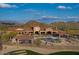 Aerial view of the community pool with mountain views, outdoor seating, and desert landscaping at 9041 E Ivyglen Cir, Mesa, AZ 85207