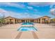 Beautiful community pool with a hot tub and plenty of seating areas at 9041 E Ivyglen Cir, Mesa, AZ 85207