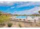 Expansive community pool area surrounded by desert landscape and lounge chairs at 9041 E Ivyglen Cir, Mesa, AZ 85207