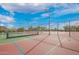 Outdoor tennis courts with manicured landscaping and open skies, ideal for recreational play at 9041 E Ivyglen Cir, Mesa, AZ 85207