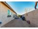 Private backyard area with gravel, block wall, and partial view of adjacent structure offers security at 9286 W Buckhorn Trl, Peoria, AZ 85383