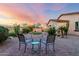 Private backyard featuring desert landscaping, brick patio, and sunset views at 9286 W Buckhorn Trl, Peoria, AZ 85383