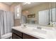 Bathroom featuring a double vanity with white countertops, and a shower with a curtain at 9286 W Buckhorn Trl, Peoria, AZ 85383